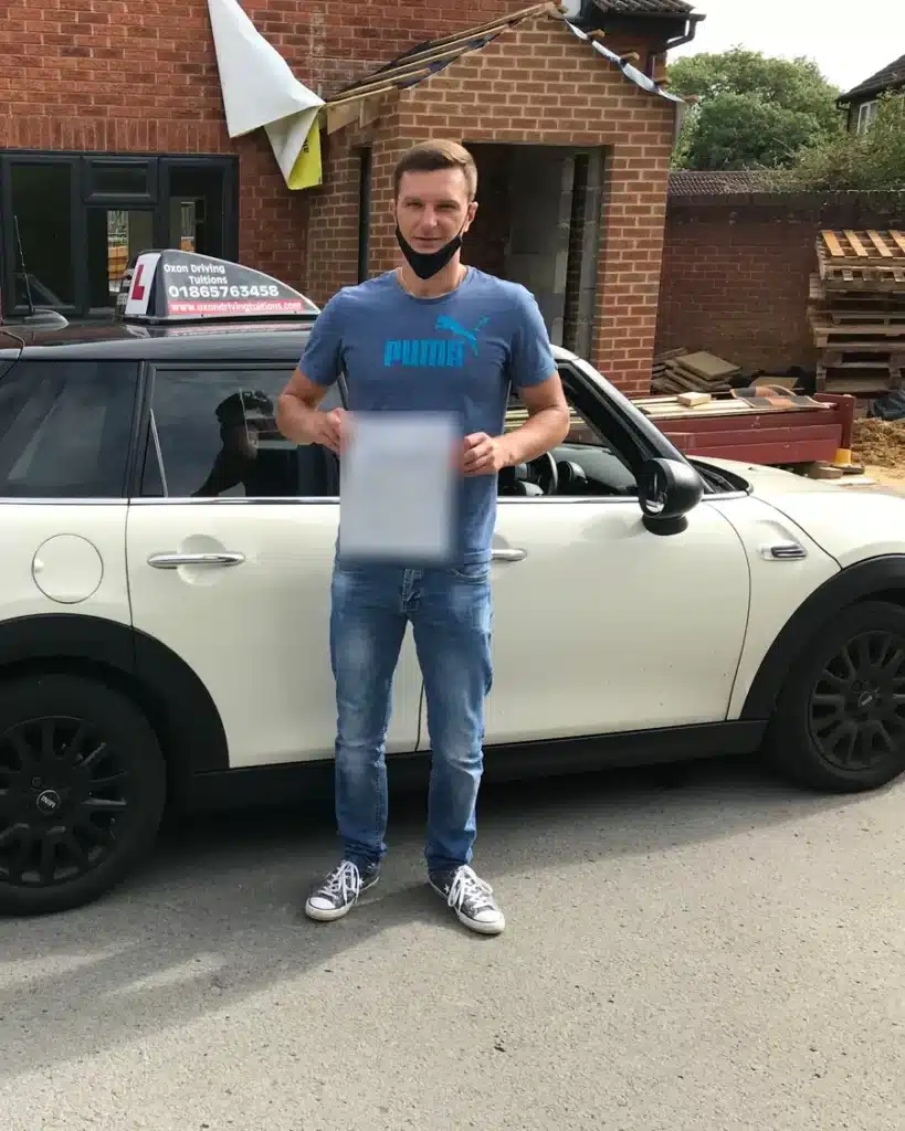 Kennington learner driver holding his driving test pass certificate beside an Oxon Driving Tuitions Mini