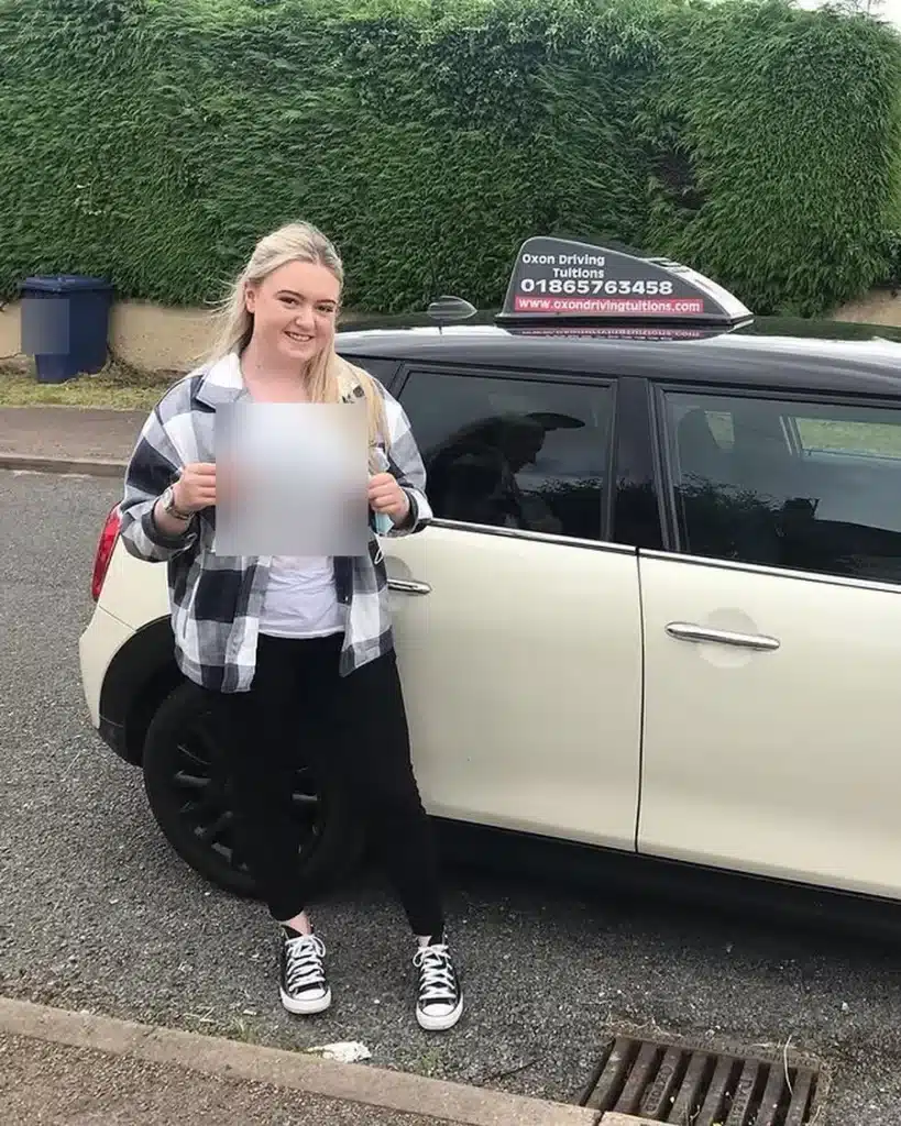 Rose Hill learner driver holding her driving test pass certificate beside an Oxon Driving Tuitions Mini