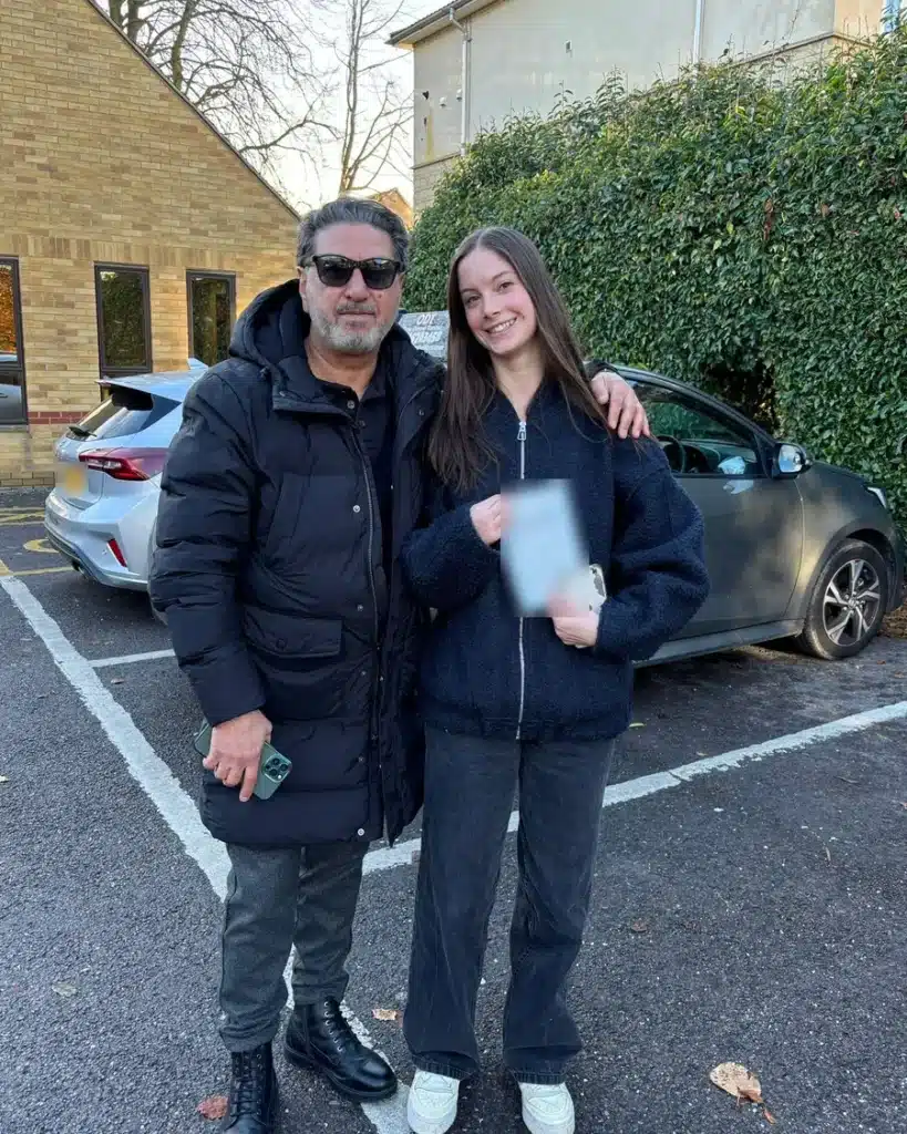 Jan Jan, an automatic driving instructor at Oxon Driving Tuitions, with a learner holding her pass certificate